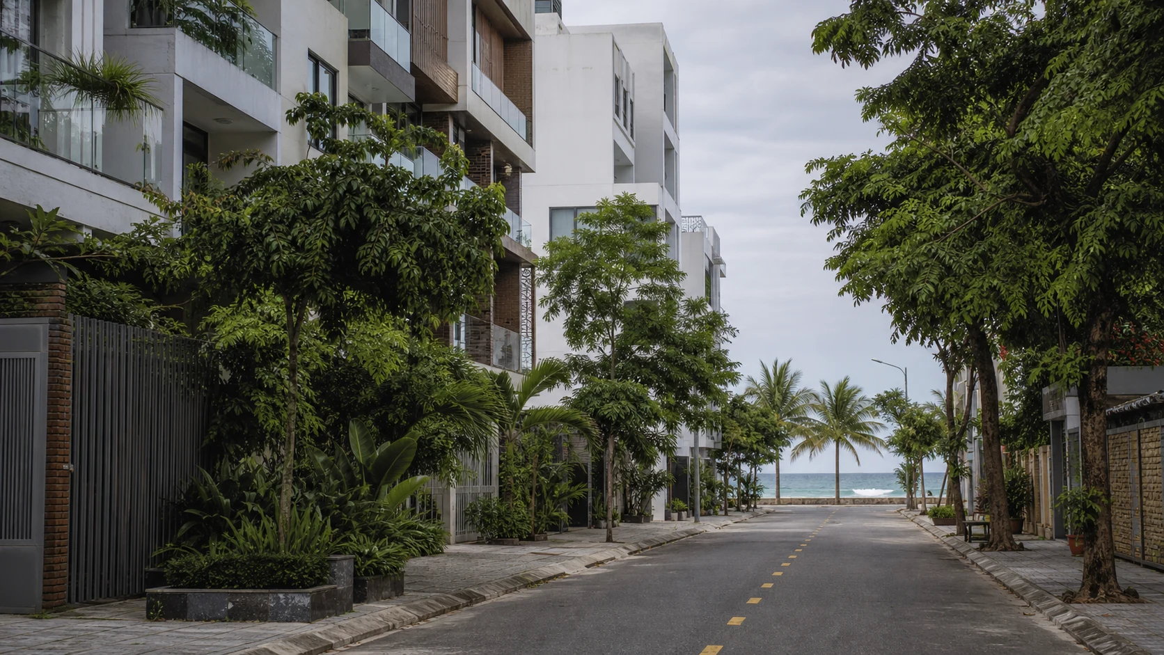 Green residential street near the Da Nang coast with contemporary apartments and tropical planting