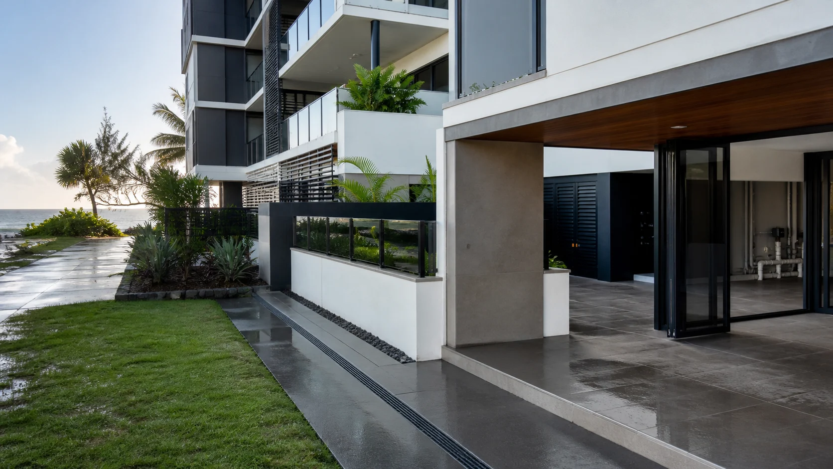 Modern coastal apartment building with wet-weather drainage, balconies and shared service areas