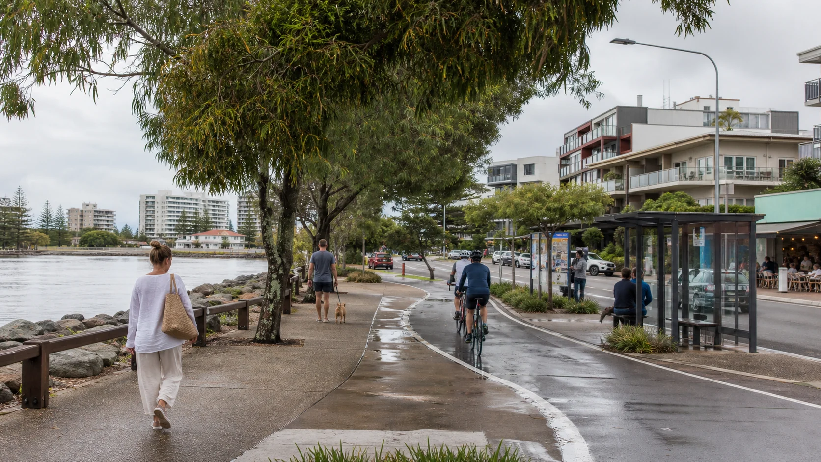 Cotton Tree riverside path, buses, cafes and apartment buildings after rain