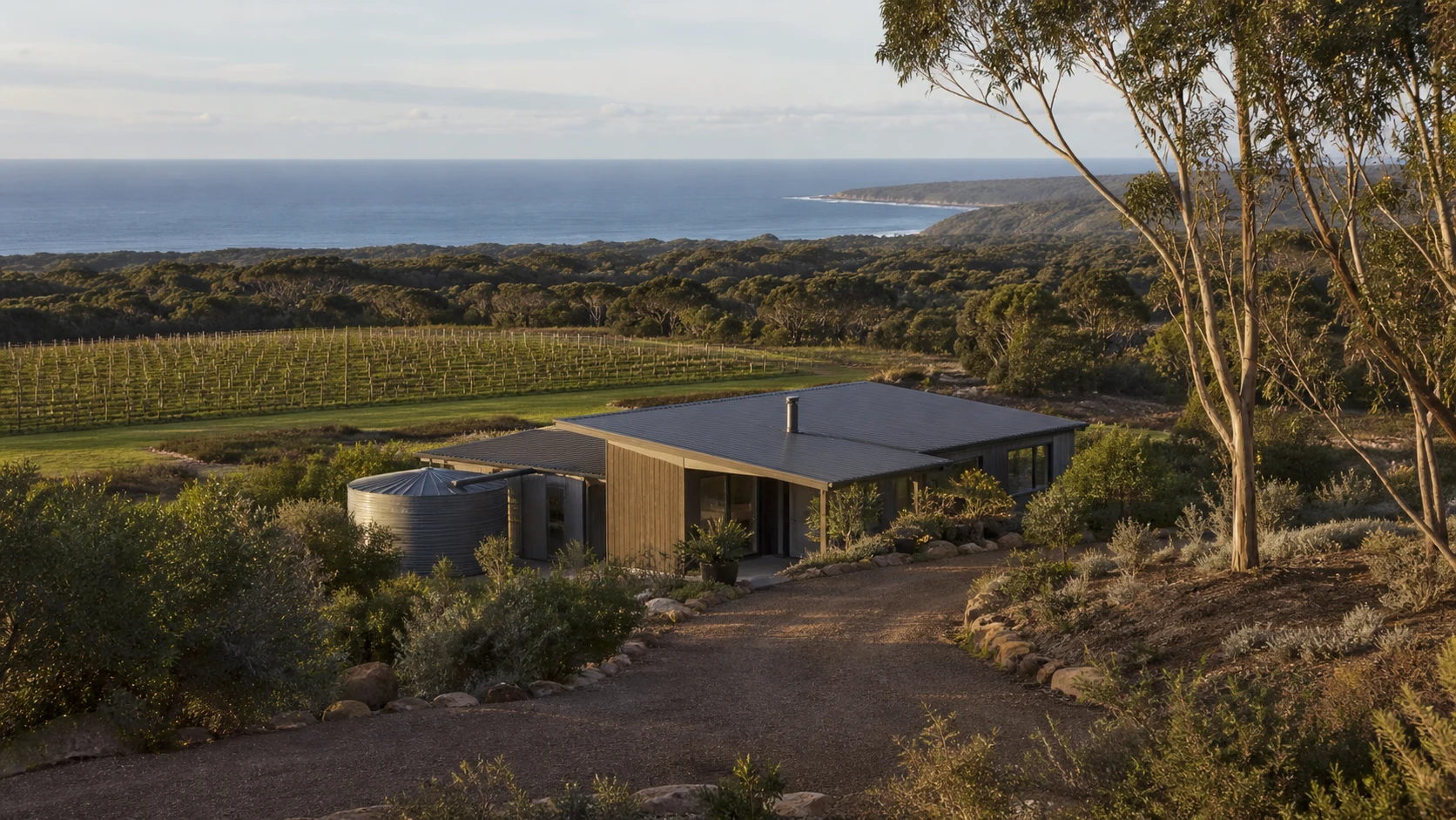 Contemporary Margaret River home with water tank, vineyard, native bush and the coast beyond